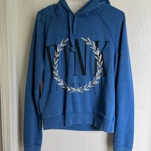 Blue sweatshirt. Pink brand.